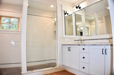 White bathroom with glass door shower